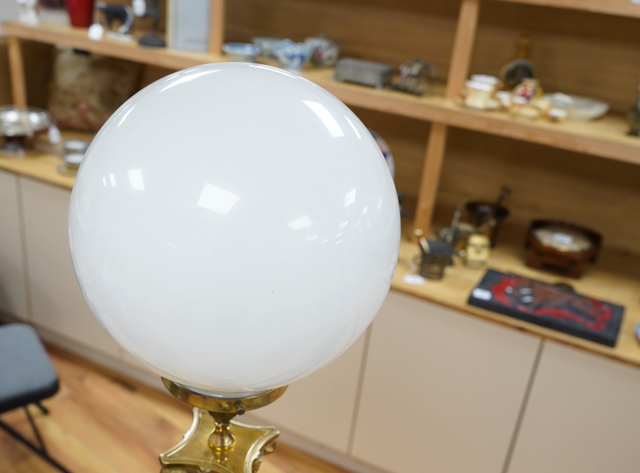 A tall brass Corinthian column table lamp with spherical glass shade, 84cm high including glass shade. Condition - good, brass tarnished at base